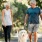 a man and a woman walking a dog on a leash