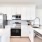 a kitchen with white cabinets